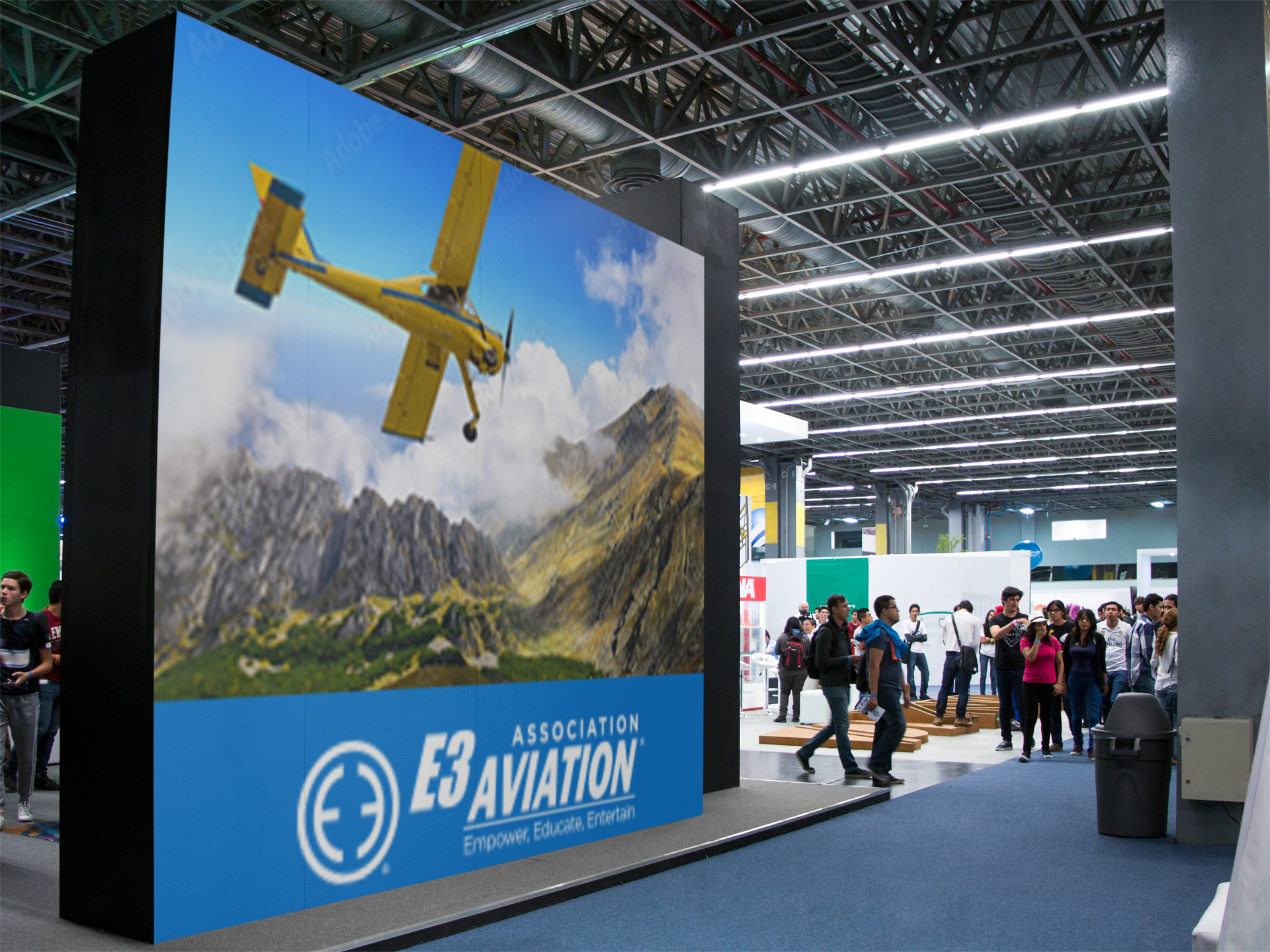 E3 Aviation convention banner — Empower, Educate, Entertain — in a busy exhibit hall