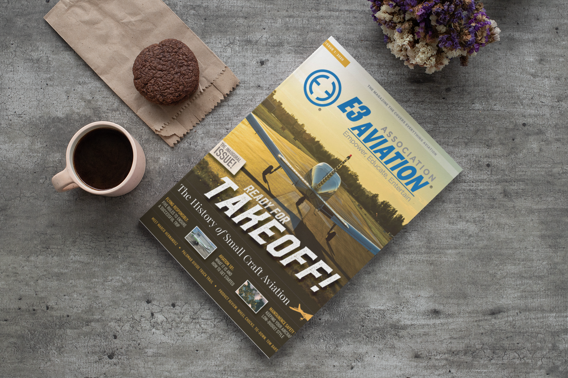 E3 Aviation Digital Pilot Magazine — Inaugural Issue, sitting on a table with a coffee and a cookie